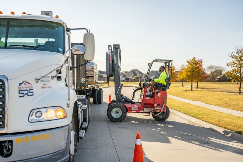 Loading a roofing truck with shingles.